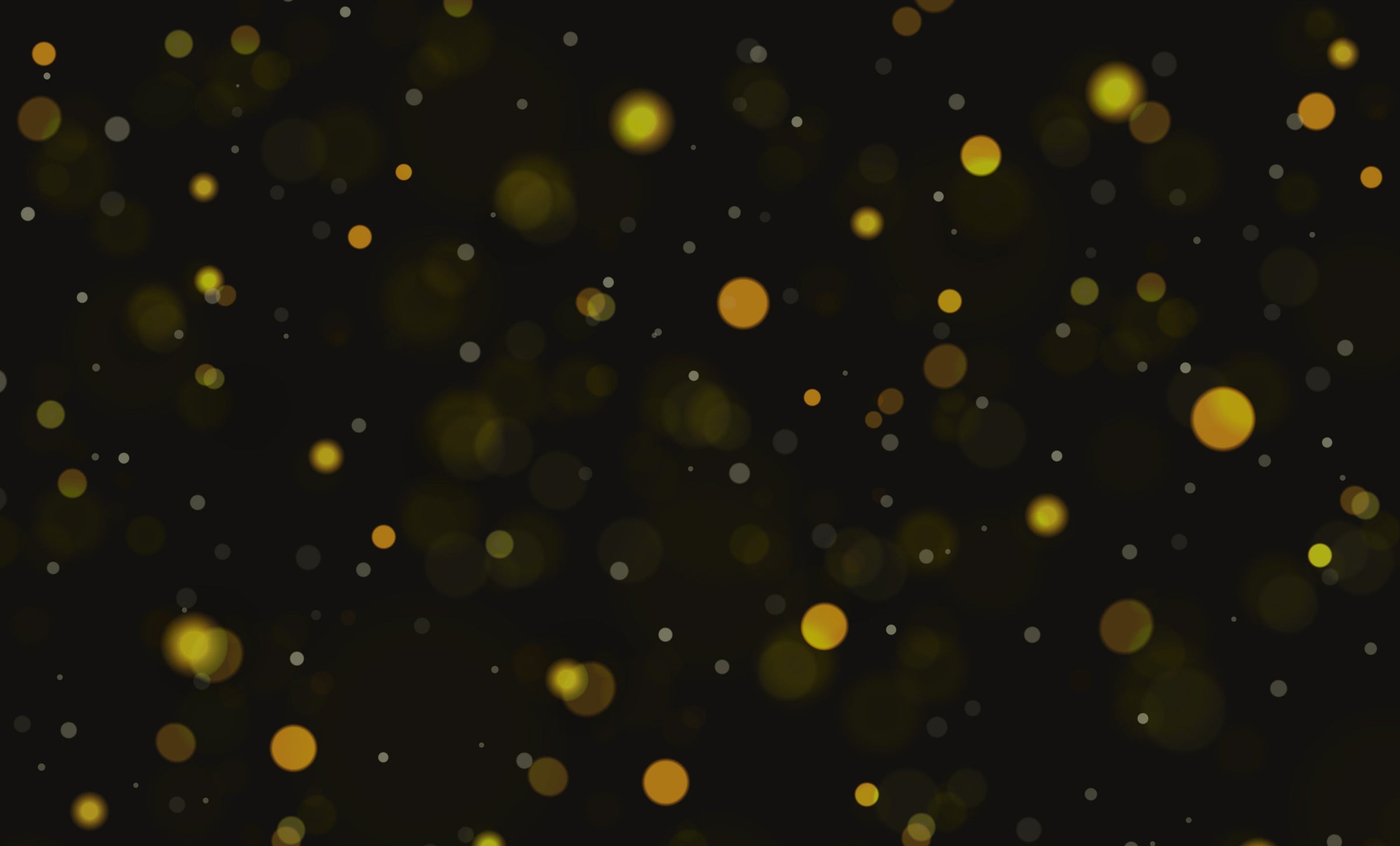 Bokeh effect with gold and white dots on a black background